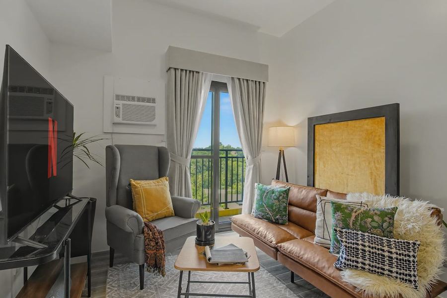 Living room with gallery wall and balcony view at the Davao City unit