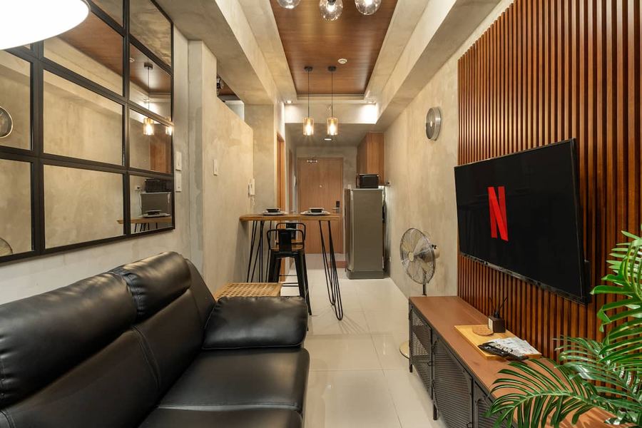 Black leather sofa living room at Shore Residences, near MOA and NAIA